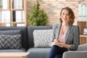 A female psychologist sitting in an armchair at her office.