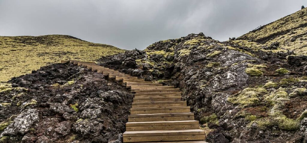 A long staircase extending into the horizon, representing the ongoing journey of the third step in addiction recovery, signifying progress, hope, and the path towards a brighter future.