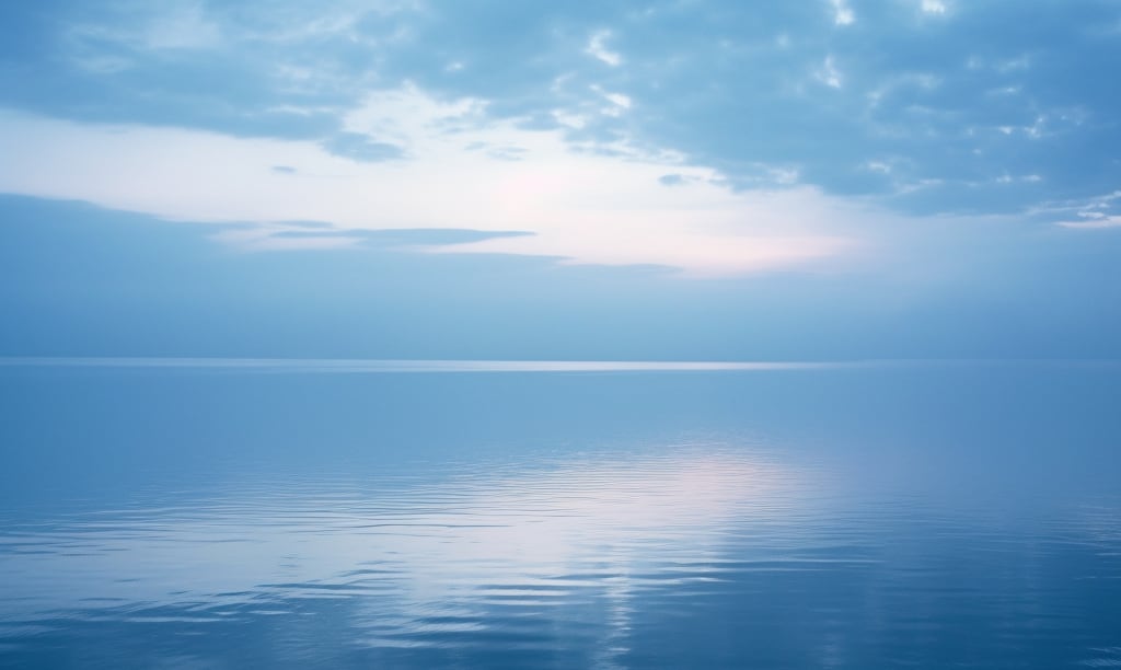 Calm waters of a lake with the sun peeking through clouds in the distance, representing the peace and new beginnings in overcoming alcoholism and trauma.