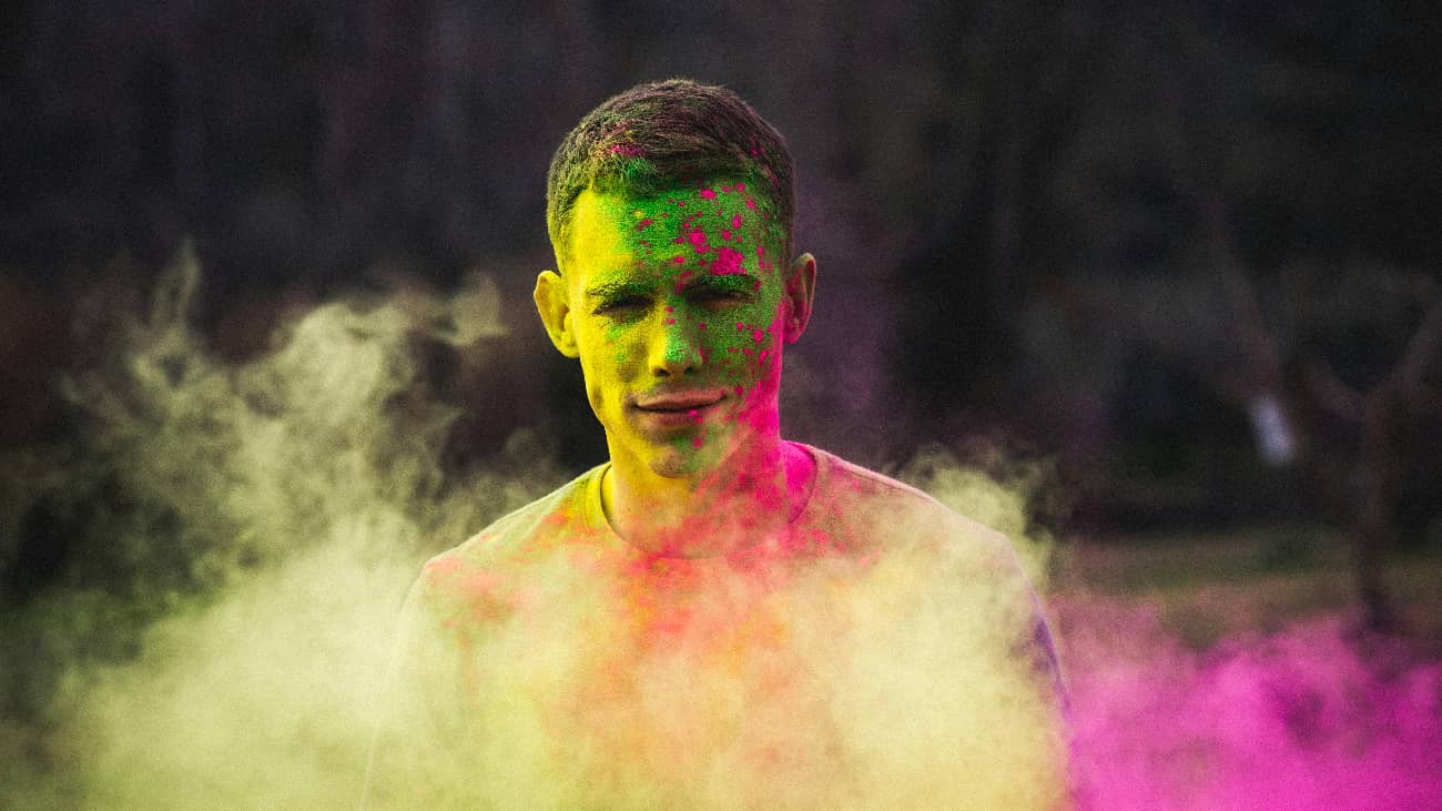 Close-up of a man's face covered in green powder, illustrating the physical manifestation and impact of using the Molly drug.