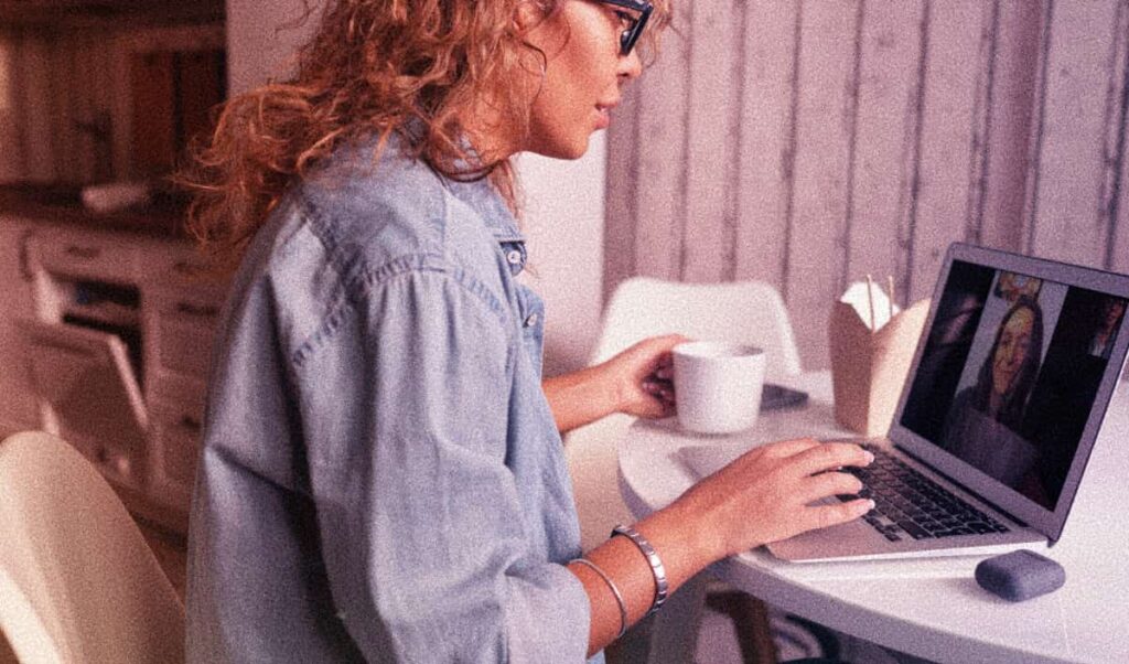 Woman sits at her desk keeping things together despite being a functioning alcoholic