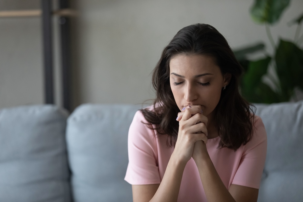 Woman praying inside a Christian rehab center in Orange County CA