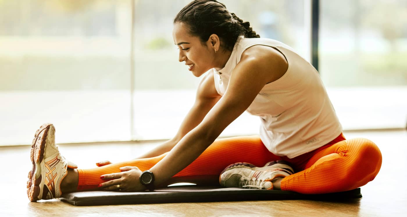 Woman stretches after a workout showing a healthy mindset that goes with nutrition in alcohol rehab and recovery.