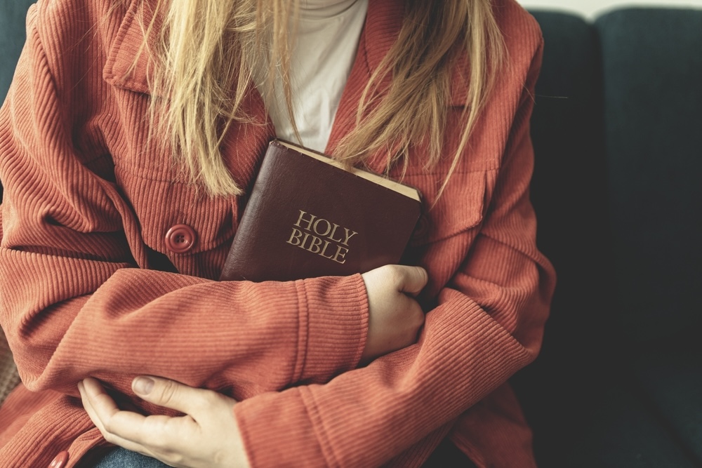 Woman holding the Bible while at a Christian rehab center for women