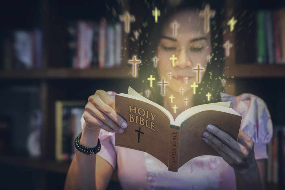 Woman reading the Holy Bible during the Christmas season 