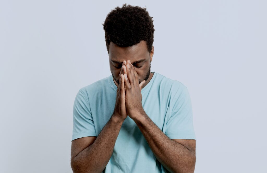 Man crying while feeling that he needs to forgive himself