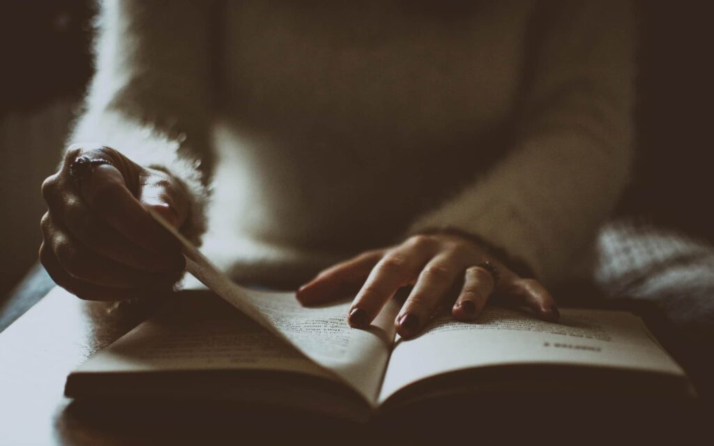 Up close of a woman reading the Bible to show the biblical principles in Celebrate Recovery.