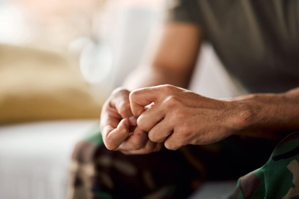 Close-up of a person nervously wringing their hands, reflecting how anxiety can make me drink.