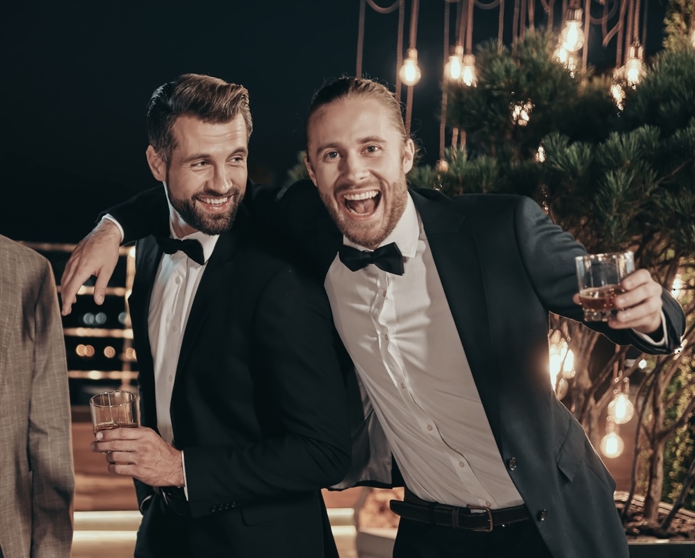Two men having fun while drinking alcohol